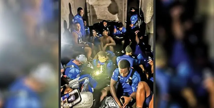 Fijian Drua players at the back of the truck.