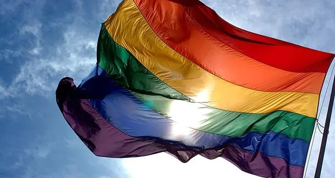 1600px-Rainbow_flag_and_blue_skies