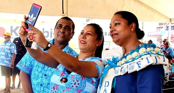 From left: Member of Parliament Joseph Nand taking in a selfie with a Sigatoka resident and the Minister for Local Government Premila Kumar at Sigatoka on October 10, 2020. Photo: DEPTFO News