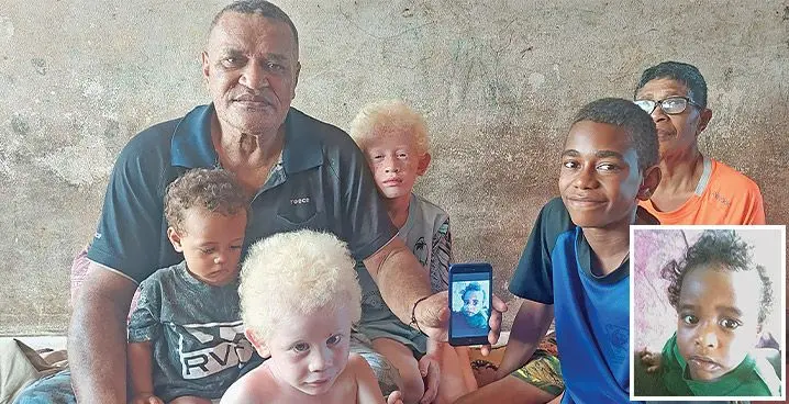 Bila Curuevalenibula (holding the phone) shows a photo of his late granddaughter, Talei Biuniceva alongside some of his grandchildren, from left; one-year-old Susana Biuniceva, three-year-old Lewis Henry, eight-year-old Brenda Biuniceva, 12-year-old Uraia Ratu, and his wife, 65-year-old Kalo Tadulala inside their home at Natokowaqa Housing in Lautoka on January 17, 2023. Photo: Nicolette Chambers Inset: The late, one-year-old Talei Biuniceva.