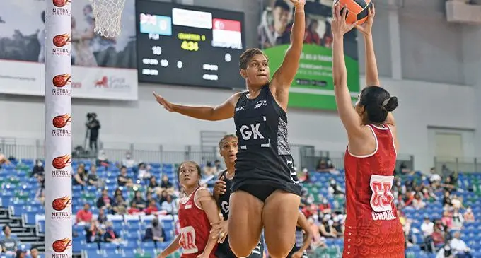 Fijian Pearls goalkeeper Merelita Waqanidrola defends against Sinapore shooter duriong their match at the ations Cup in Singapore on December 5, 2022. Photo: Netball Singapore