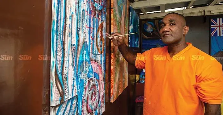 Fiji Corrections Service inmate Filimoni Vetaukula, with his work of art dispayed at the Tagimocia Art Gallery in Suva on November 20, 2023. Photo: Leon Lord