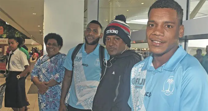 Fiji Airways Fijian 7s rep Napolioni Ratu (closest to camera) and Vilimoni Botitu (third from right) with fans at the Nadi International Airport on March 28, 2019. Photo: Waisea Nasokia