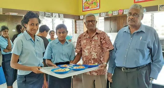 President and manager of the School and Society for Handicapped, Dorsami Naidu (far right) and assistant president, Anand Ramand, handing over lunch to students at the Nadi Centre for Special Education on  October 15, 2020. 