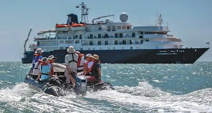 Passengers returning to the MS Caledonian Sky .
