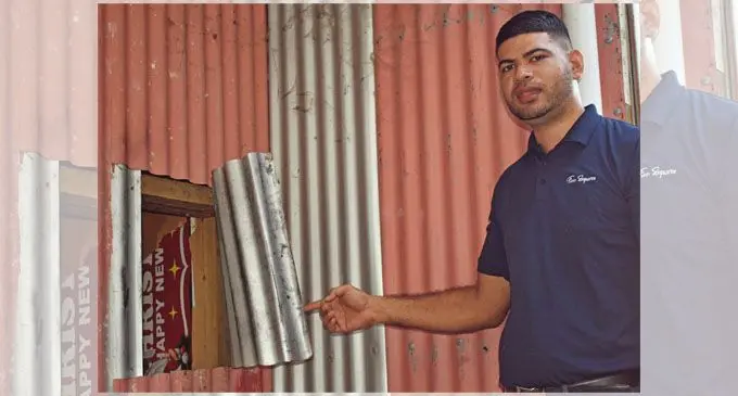 Five Squares sales representative, Greg Fisher, shows the entry point of the alleged break-in at their shop.   Photo: Waisea Nasokia