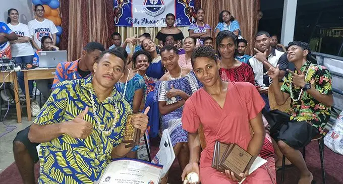 Mahatma Ghandi Memorial School sprinters Waisele Inoke (left) and Kesaia Boletakanakadavu with the MGM athletes during their celebration on August 24, 2022. Photo: Laiseana Nasiga