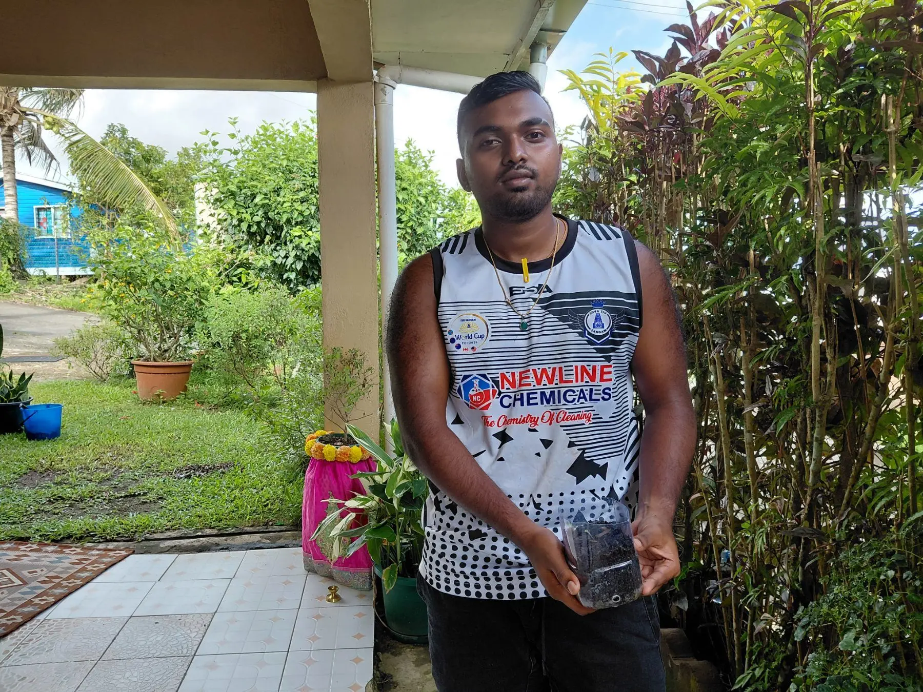 Bhaveekesh Reddy shows his recycled bottle planting system used to grow seedlings at his home-based farm on December 26, 2025.
