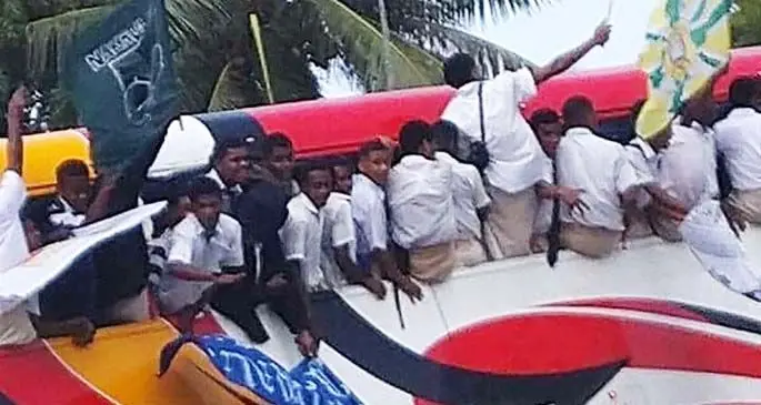 Children photographed sitting on the edge of windows and some were hanging out of windows swinging their flags.