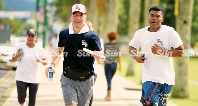 French Ambassador to Fiji Francois-Xavier Leger holds the baton and para-athlete Leslie Tikotikoca (right) during the run-a-thon marking the International day of Sport for Development and Peace in Suva on April 6, 2022. Photo: Ronald Kumar