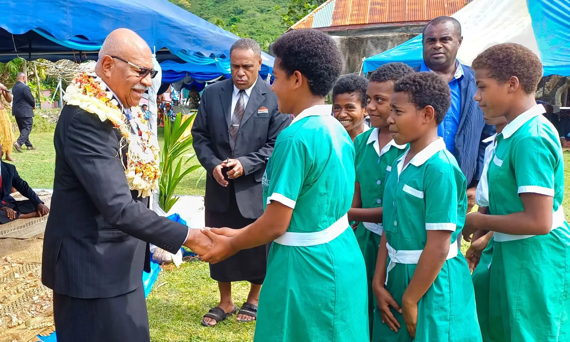 Prime Minister Sitiveni Rabuka engaging with schoolchildren during a public event.