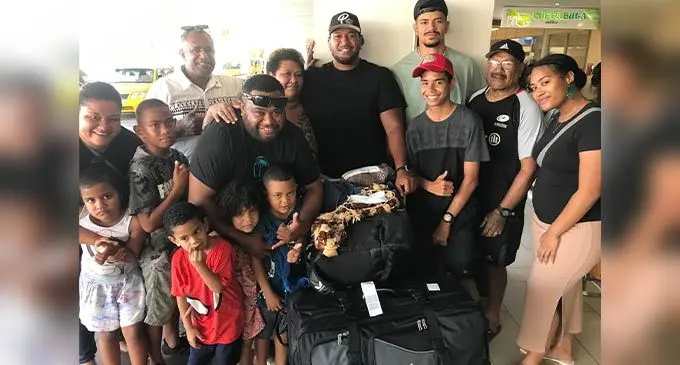 Vodafone Flying Fijians prop Eroni Mawi with famliy members and Saracens team-mate Theodore McFarland at Nadi International Airport on June 26, 2022. Photo: Waisea Nasokia