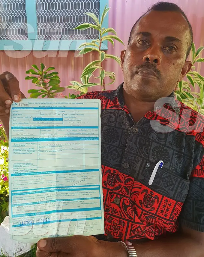 Babu Suresh Sharma with his late son’s post-mortem examination result.   Photo: Nicolette Chambers
