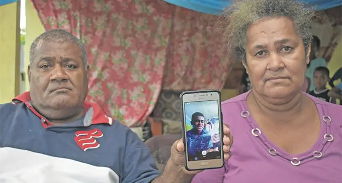 Pastor Kavekini Varo, with wife Mereseini Sivo, holds a photo of their late son Mosese Namumu Kubunavanua at their residence in Navakai, Nadi on April 25, 2019. Photo: Waisea Nasokia
