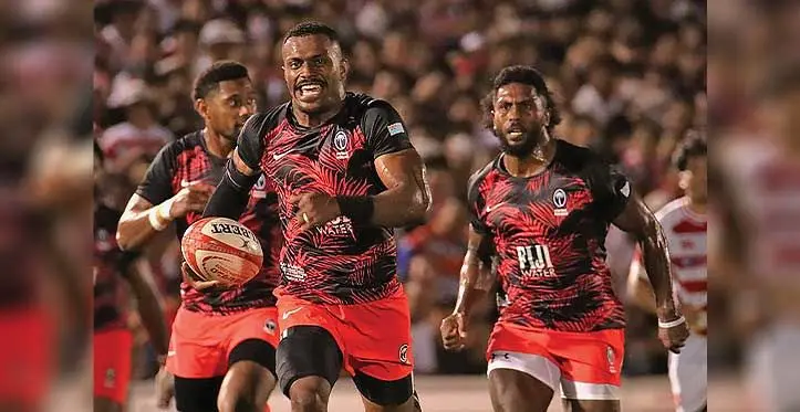 Jiuta Wainiqolo of the FIJI Water Flying Fijians on his way to score a try against Japan. Photo: AFP
