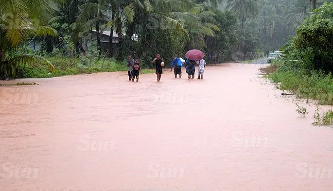 Muaivuso Road residents had to walk through flooded roads to reach home as the road was closed to all motorist due to flooding on April 27, 2020. Photo: Ronald Kumar.