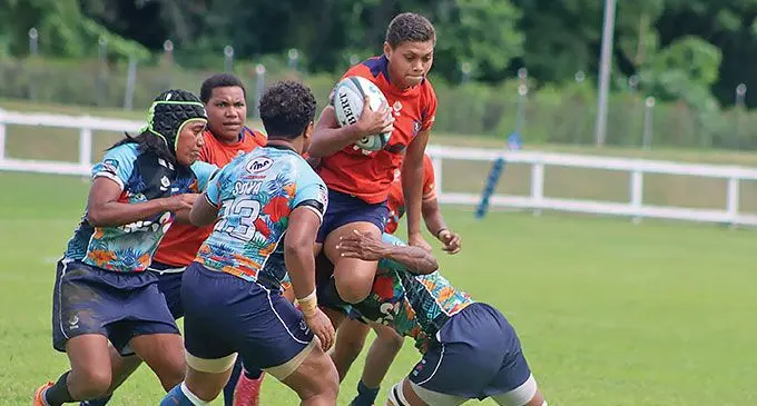 A Nasinu player tries to break away from Suva players at Lawaqa Park, Sigatoka on May 18, 2024. Photo: FRU Media
