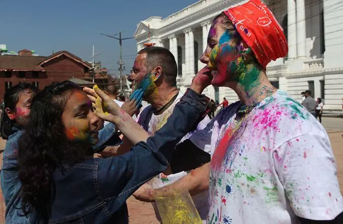 People put colour powder to each other in the celebration of Holi Festival in Kathmandu, capital of Nepal, March 9, 2020. (Xinhua/Sunil Sharma) 