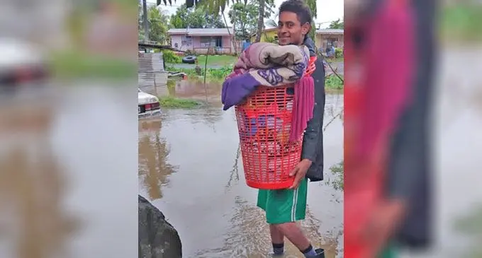 Kolinio Talemailebo gathers a few home supplies while being evacuated in Tavualevu Village, Tavua