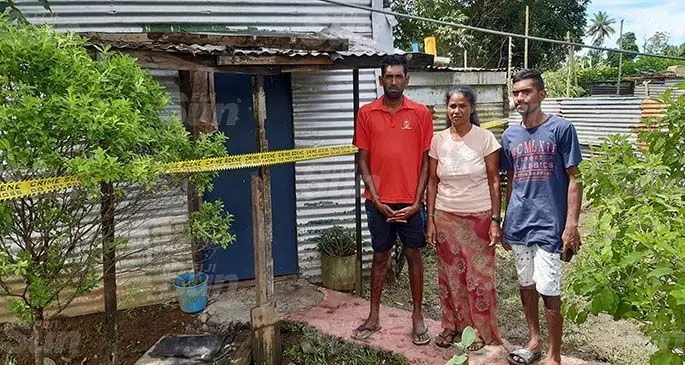Ronal Lal, Indra Wati and Shiu Kumar standing in front of the house where Sonam Lal was found to have been on fire. Photo: Shalveen Chand