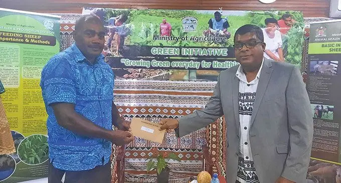 Minister for Agriculture Mahendra Reddy with Central Division livestock farmer Joji Ramotiqa.