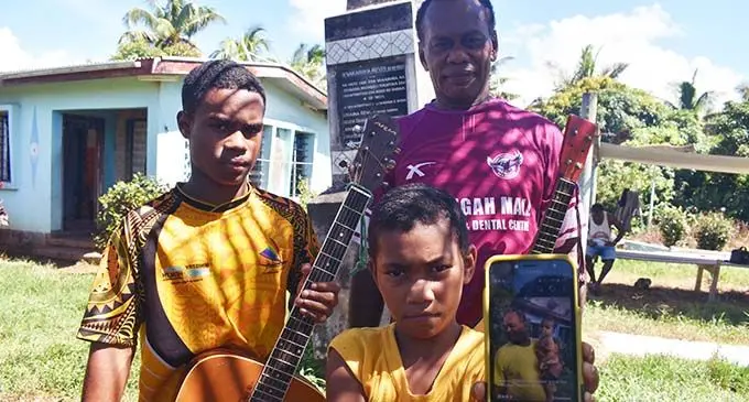 Eparama Draso, 53 with his grandchildren Naomi Naisau, 9 and Epeli Duvedraso, 15 with the music intruments of late Joeli Walevu at their residence in Koroqaqa village in Ba yesterday. Photo: WAISEA NASOKIA