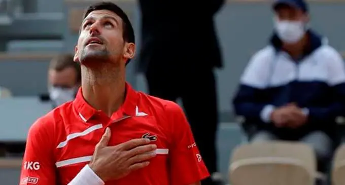 Serbia's Novak Djokovic celebrates winning his second round match of the French Open tennis tournament against Lithuania's Ricardas Berankis at the Roland Garros stadium in Paris, France, Thursday, Oct. 1, 2020.