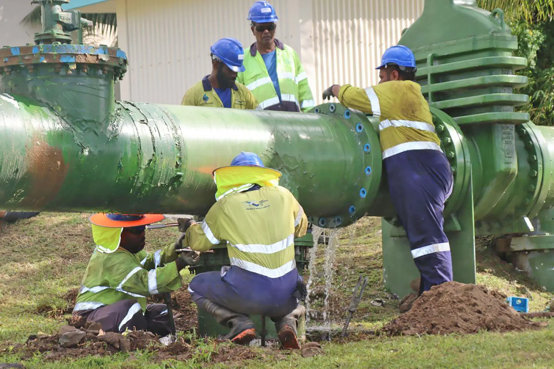Water Authority of Fiji technicians work on supply pipes.