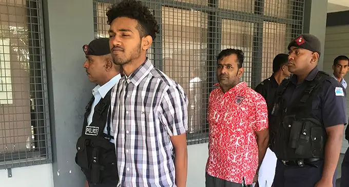 Saimum Dean (red shirt) and Zuhair Frahaad Dean escorted by Police outside the Magistrate Court in Labasa on May 5, 2020. Photo: Shratika Naidu