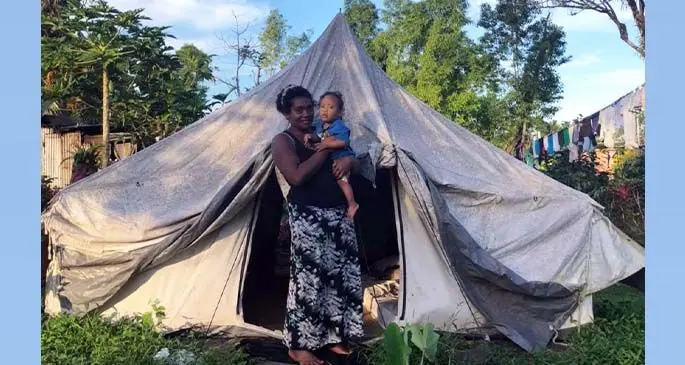 Piniaua Vukicanatani and her son infront of her makeshift tent in Culunuku Village, Serua.