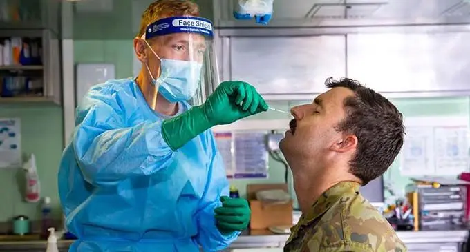 Royal Australian Navy Doctor, Lieutenant Nicholas Ilijas, conducts a COVID-19 test onboard HMAS Adelaide as part of the COVID-19 safety protocols for Operation Fiji Assist. Photo: Australian Defence Force