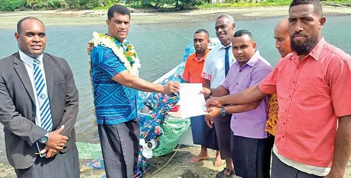 Minister for Education Aseri Radrodro (second from left), handing over boat and engine to the staff of Saqani district and Saqani High School.