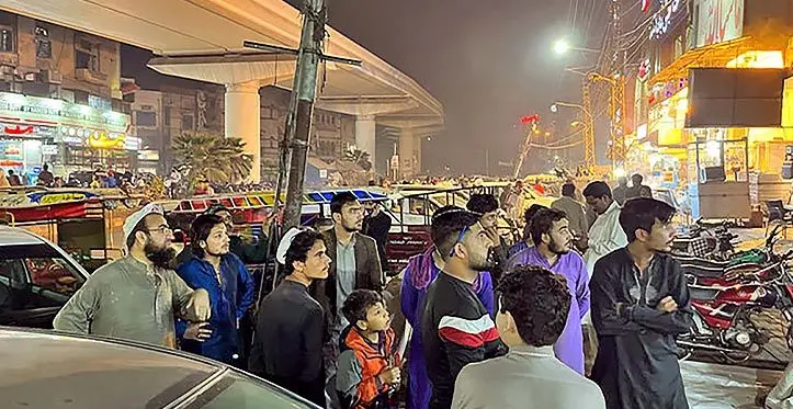 People came out of a restaurant after a tremor was felt in Lahore, Pakistan on ► March 21, 2023. Photo: Reuters