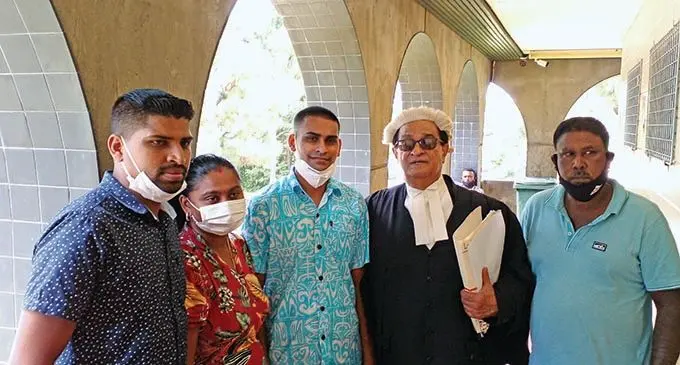 Ronald Kumar (first from left), Ashneel Avishay Kumar (third from left) and defence lawyer Iqbal Khan and family members at the High Court in Lautoka on January 4, 2022.   Photo: Salote Qalubau 