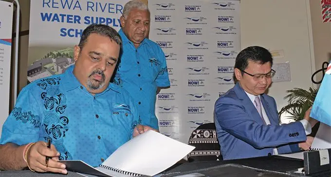 Water Authority of Fiji chairperson Bhavesh Kumar (seated left), and Ji Xiayong of Sinohydro-HDEC JV sign the contract for the Rewa River Water Supply Scheme in the pres- ence of the Prime Minister Voreqe Bainimarama at the Grand Pacific Hotel on April 11, 2019. Photo: Ronald Kumar