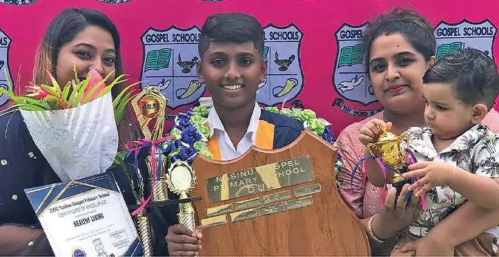 From left: Menika Singh, Dux Marvin Kumar and Morishna Singh with her baby Ivan Singh at the Nasinu Gospel Primary School prizegiving ceremony at the FMF Gymnasium on the 23 of November 2023. Photo: Sosiveta Korobiau