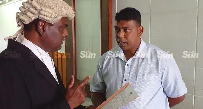 Praneel Prakash Sen speaks with his lawyer Jitendra Reddy outside the High Court in Lautoka on April 4, 2022. Photo. Salote Qalubau.