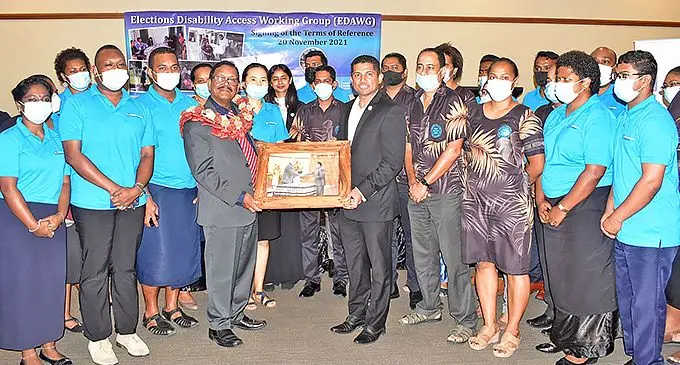 Former Chairperson of the Fijian Electoral Commission Suresh Chandra receiving a parting gift from Supervisor of Elections Mohammed Saneem on November 20, 2021. Photo: Fijian Elections Office