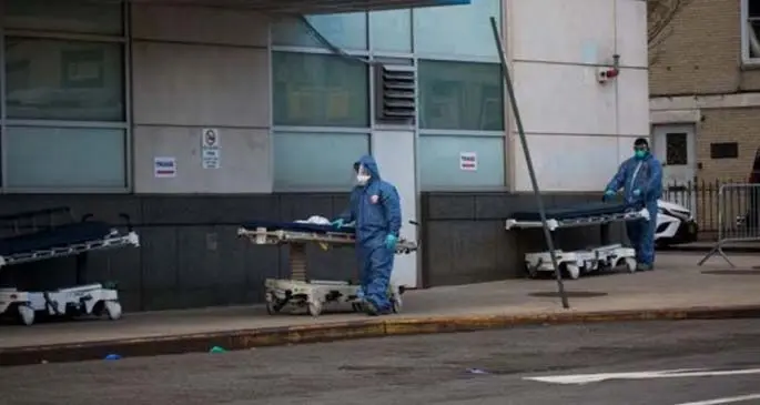 Healthcare workers wheel hospital beds in front of Maimonides Medical Center during the coronavirus pandemic in the Brooklyn borough in New York, the United States, April 8, 2020. (Photo by Michael Nagle/Xinhua)