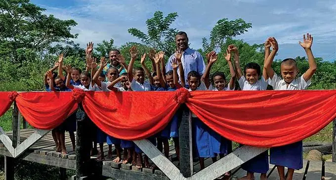 Minister for Rural and Maritime Development and Disaster Management, Inia Seruiratu with children of Nawamagi Village.