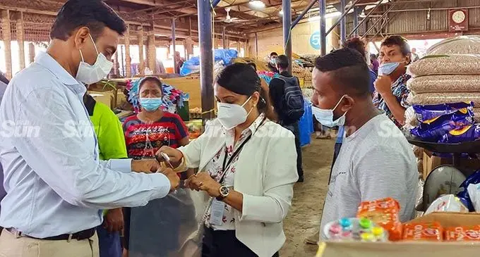 Permanent Secretary for Environment, Joshua Wycliff, (left) uses a vernier caliper to measure the size of the plastics found at a stall in Labasa market on February 8, 2022. Photo: Sampras Anand