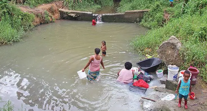 Villagers of Waiqanake outside Lami washing laundry at the creek.