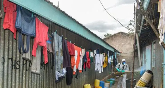 A health worker disinfects a home at Kawangware slums in Nairobi, capital of Kenya, on May 2, 2020. (Photo by Joy Nabukewa/Xinhua)