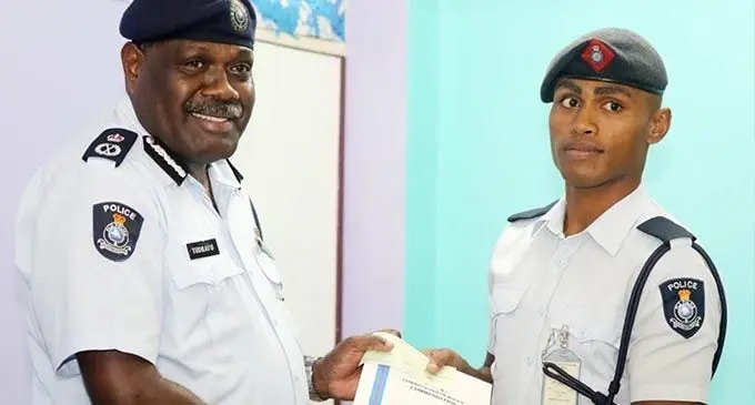 Acting Commissioner Rusiate Tudravu presents Police Constable Peni Cavuilagi a Certificate of Commendation for assisting a victim of an alleged aggravated robbery case in Balawa, Lautoka last month.
