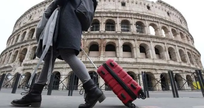 A woman walks past the Colosseum in Rome, Italy, on March 13, 2020. (Photo by Elisa Lingria/Xinhua)