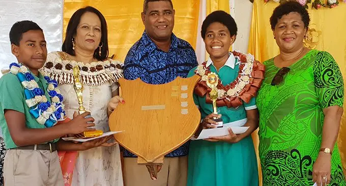 The Minister for Education, Heritage and Arts, Rosy Akbar (second from left) presenting the dux award to the two dux of Ahmadiyya Muslim Primary School in Lautoka Adi Kuila Sova (second from right) and Mohammad Nadeem (first from left) and father of Adi Kuila Sova at the school’s annual awards day on November 14, 2019.   Photo: Nicolette Chambers