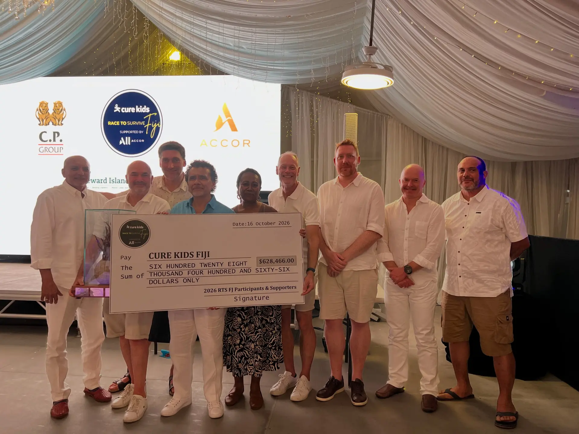 Cure Kids Fiji chairman Tony Whitton with the cheque and the executives.