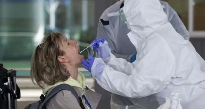 A passenger from Europe receives a test at an Open Walk-Through checkpoint in Incheon International Airport, South Korea, March 27, 2020. (Photo by Lee Sang-ho/Xinhua)