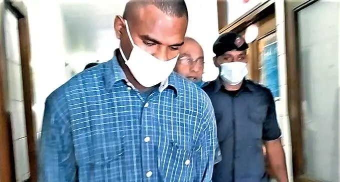 Alivereti Lesukiyasawa (left) being escorted out of the High Court in Lautoka on March 22, 2022.  Photo: Salote Qalubau
