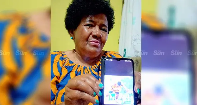 Elijah Tokikivunuku’s mother, Maraia Wedlock, with a  photo of her son that’s been ridiculed on social media. Photo: Ronald Kumar